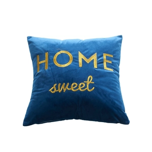 Navy blue velvet throw pillow with gold Home Sweet embroidery on a clean white background