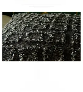 Detailed close-up of dark grey polyester-cotton cushion cover with 3D tassel grid texture