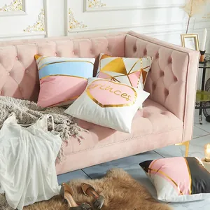 Modern geometric cushion cover with gold foil accents and Princess text on pink sofa