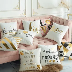 Modern minimalist decorative gold stamped throw pillow covers set on a pink velvet sofa