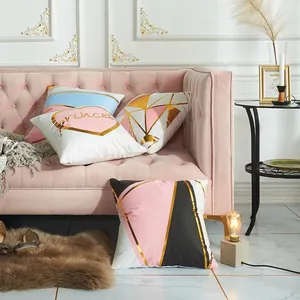 Modern geometric and lettered cushion covers set on pink sofa with gold foil accents