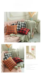 Detail showing checkered plaid pillowcase texture with pom-pom trim on a pink sofa