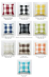 Detail view of plaid linen pillow covers with pom-pom fringe in ten different colors