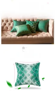 Detailed view of green jacquard cushion covers with textured patterns on a sofa