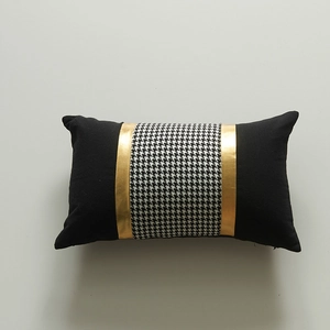 Modern black throw pillow cover with houndstooth pattern and golden leather stitching accent