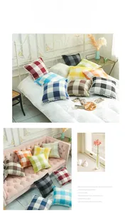 Detail of plaid linen pillow covers featuring white decorative pom-pom fringe trim
