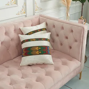 Ethnic style velvet throw pillow covers with colorful geometric ribbon on pink sofa
