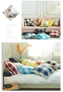 Detail of linen plaid pillowcase with pom-poms and hidden zipper closure in various colors
