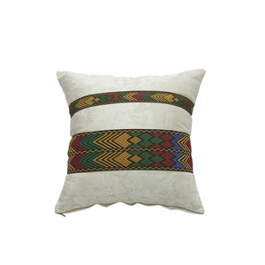 Square beige velvet pillow cover featuring colorful ethnic geometric woven ribbon trim