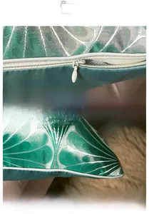 Detail of hidden zipper and piping on green jacquard geometric cushion cover