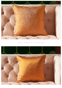 Detail of orange velvet cushion covers featuring embossed leaf veins and glitter textures