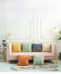 Detail of colorful lamb wool pillow covers with elegant geometric gold foil branch patterns