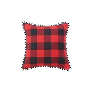Square red and black buffalo plaid pillow cover with decorative black pom-pom trim