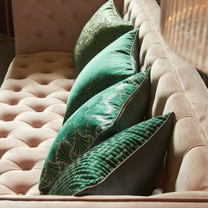 Modern dark green velvet decorative throw pillow covers with gold patterns on a pink sofa