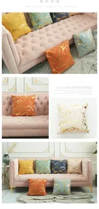 Close-up of velvet pillow covers featuring elegant gold foil branch texture patterns