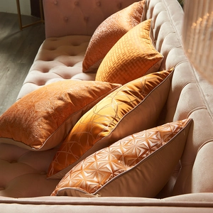 Modern geometric orange cushion covers set with jacquard texture on velvet sofa