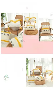 Detail of bohemian cotton tufted cushion covers with yellow tassels and geometric patterns