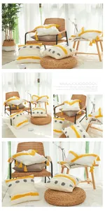 Close-up of bohemian cotton tufted cushion cover with yellow tassels and textures