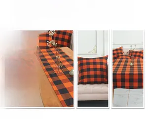 Detail of orange and black buffalo plaid table runner and matching pillow covers set