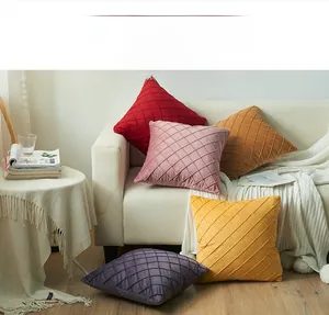 Close-up of diamond lattice quilted velvet pillowcases in multiple warm colors