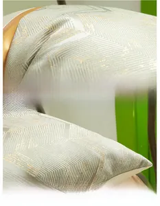 Detail of Nordic style gold jacquard and brown faux leather patchwork pillowcase