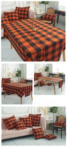 Detail of orange and black buffalo plaid table runner, tablecloth and matching pillow covers