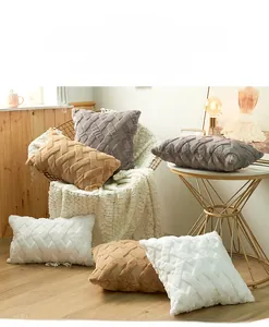 Close-up of geometric plush pillow covers with chunky woven texture in neutral tones