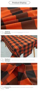 Detail of orange and black checkered tablecloth showing thick canvas fabric and fine stitching