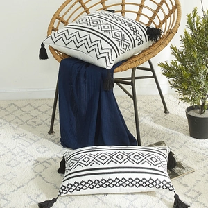 Moroccan boho chenille pillow cover with geometric pattern and black corner tassels