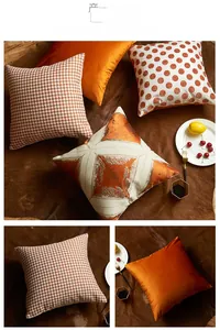 Detail of orange and white square pillow covers in houndstooth and dot patterns