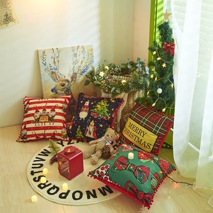 Christmas pillow covers with pom-pom edges featuring Santa and festive plaid patterns