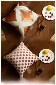 Detailed view of luxury orange velvet pillow cover with metallic foil geometric pattern