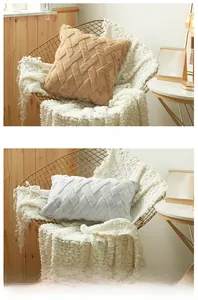 Detailed view of plush camel and white cushion covers with geometric woven textures