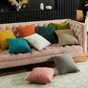 Minimalist solid color cushion covers with diamond embossed texture on pink velvet sofa