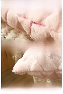 Detail of pink plush pillow cover showing invisible zipper and diamond geometric texture