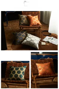 Detail of jacquard pillow cover featuring dark green fabric and gold piping on leather chair