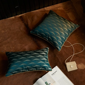 Teal and gold geometric triangle jacquard cushions with luxury piping on a fur rug