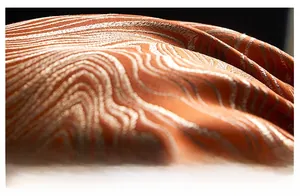 Macro view of high-quality orange and beige jacquard fabric with elegant wave patterns