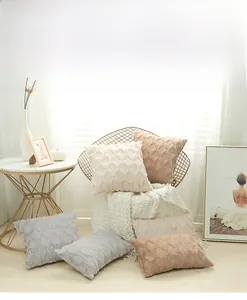 Detailed close-up showing geometric diamond pattern and textured embroidery on plush pillow covers