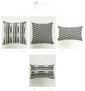 Detail view of black and white geometric cushion covers with stripes and 3D grid patterns