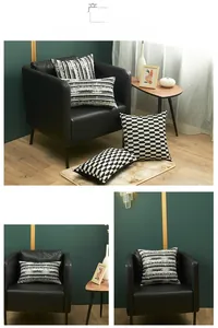Detail view of monochrome jacquard pillow set with geometric patterns on a black leather chair