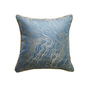 Modern navy blue throw pillow cover with golden wave pattern and piped edges