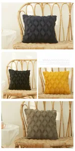 Close-up of 3D geometric diamond plush cushion covers in yellow, black, and brown