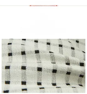 Close-up of black and white jacquard weave cushion fabric with tassel fringe texture