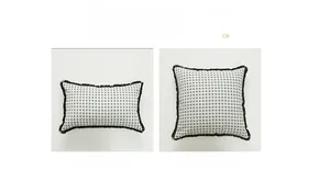 Detail of minimalist black dot jacquard cushion cover with decorative fringe edges