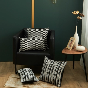 Modern Italian black and white geometric jacquard pillow covers set on a leather sofa