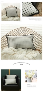 Detail of white and black checkered pillowcase with decorative fringe and soft texture