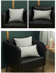 Close-up of black and white checkered cushion cover with detailed fringe edge and fabric texture