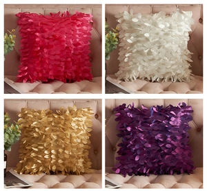 Close-up of 3D leaf textured satin pillowcases in various colors on a sofa
