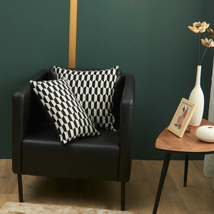 Italian jacquard cushion set with black and white geometric patterns on leather sofa